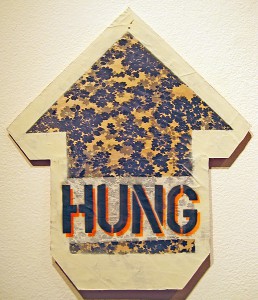 ABOVE    -  <strong>HUNG/OVER (front view)</strong> (2010<strong style = 'color:#635a27'></strong>)<bR /> mixed media on panel, 
 18 x 16 inches 
(45.72 x 40.64 cm)
