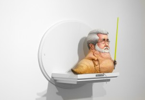 Mike Leavitt -  <strong>George Lucas (side)</strong> (2016<strong style = 'color:#635a27'></strong>)<bR /> hand-carved western red cedar, yellow cedar and acrylic paint,
18 inches (45.7 cm)