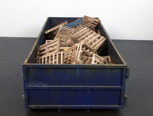 Drew Leshko -  <strong>Blue 30 Yard Dumpster with 55 Pallets</strong> (2016<strong style = 'color:#635a27'></strong>)<bR /> paper, enamel, acrylic, dry pigments, wire, wood,
5 x 21.5 x 9 inches,
(12.7 x 54.61 x 22.86 cm)