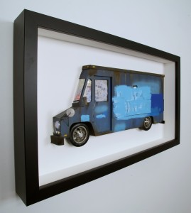 Drew Leshko -  <strong>Blue Buff LLV (side)</strong> (2016<strong style = 'color:#635a27'></strong>)<bR /> paper, enamel, dry pigments, acrylic, plastic, clay, wire, inkjet print, toy hubcaps. Framed in shadowbox without glass,
16 x 27.5 x 3 inches,
(40.64 x 69.85 x 7.62 cm)
