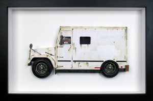 Drew Leshko -  <strong>Brinks Truck</strong> (2016<strong style = 'color:#635a27'></strong>)<bR /> paper, enamel, dry pigments, acrylic, plastic, wire, inkjet print, toy wheels. Framed in shadowbox without glass,
16 x 24 x 3 inches,
(40.64 x 60.96 x 7.62 cm)
