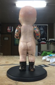 Haroshi -  <strong>Still Standing Despite the Odds (back)</strong> (2016<strong style = 'color:#635a27'></strong>)<bR /> composition doll, skateboard, wood,
12.59 x 5.51 x 4.33 inches,
(32 x 14 x 11 cm)