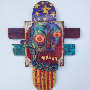Charles Bennett -  <strong>America Eats its Own</strong> (2017<strong style = 'color:#635a27'></strong>)<bR /> acrylic and spray paint on reclaimed wood and skateboard,
24 x 32 x 3 inches,
$1,000