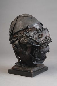 Ronald Gonzalez -  <strong>Masked Head (side)</strong> (2017<strong style = 'color:#635a27'></strong>)<bR /> manipulated found objects, wax, wire, soot, metal filings over welded steel, 	
12 x 10 x 10 inches
$2,250