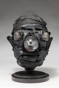 Ronald Gonzalez -  <strong>Cone</strong> (2018<strong style = 'color:#635a27'></strong>)<bR /> black leather, found objects, wire, wax, carbon, screws and metal filings over welded steel armatures.  	11 x 9 x 10 inches