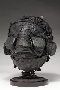Ronald Gonzalez -  <strong>Darkly (side)</strong> (2018<strong style = 'color:#635a27'></strong>)<bR /> black leather, found objects, wire, wax, carbon, screws and metal filings over welded steel armatures,
12 x 10 x 9 inches