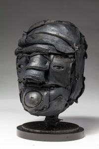 Ronald Gonzalez -  <strong>Gasp (side)</strong> (2018<strong style = 'color:#635a27'></strong>)<bR /> black leather, found objects, wire, wax, carbon, screws and metal filings over welded steel armatures,
12 x 8 x 9 inches