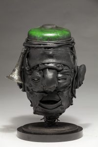 Ronald Gonzalez -  <strong>Green Cap</strong> (2018<strong style = 'color:#635a27'></strong>)<bR /> black leather, found objects, wire, wax, carbon, screws and metal filings over welded steel armatures,
12 x 9 x 7 inches