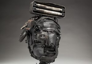 Ronald Gonzalez -  <strong>Lamp (detail)</strong> (2018<strong style = 'color:#635a27'></strong>)<bR /> black leather, found objects, wire, wax, carbon, screws and metal filings over welded steel armatures,
13 x 8 x 7 inches