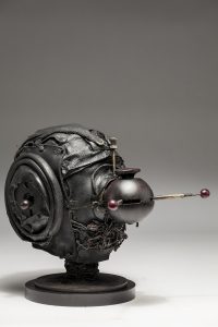 Ronald Gonzalez -  <strong>Messenger (side)</strong> (2018<strong style = 'color:#635a27'></strong>)<bR /> black leather, found objects, wire, wax, carbon, screws and metal filings over welded steel armatures,
11 x 9 x 12 inches