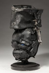 Ronald Gonzalez -  <strong>Open To Pain (side)</strong> (2018<strong style = 'color:#635a27'></strong>)<bR /> black leather, found objects, wire, wax, carbon, screws and metal filings over welded steel armatures,
15 x 9 x 8 inches