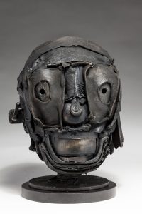 Ronald Gonzalez -  <strong>Skull</strong> (2018<strong style = 'color:#635a27'></strong>)<bR /> black leather, found objects, wire, wax, carbon, screws and metal filings over welded steel armatures, 
11 x 7 x 9 inches