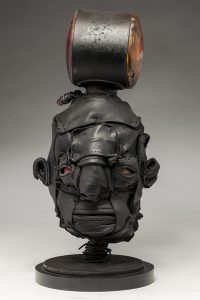 Ronald Gonzalez -  <strong>Signal</strong> (2018<strong style = 'color:#635a27'></strong>)<bR /> black leather, found objects, wire, wax, carbon, screws and metal filings over welded steel armatures,
16 x 7 x 8 inches