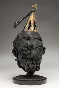 Ronald Gonzalez -  <strong>Steeple (side)</strong> (2018<strong style = 'color:#635a27'></strong>)<bR /> black leather, found objects, wire, wax, carbon, screws and metal filings over welded steel armatures,
16 x 8 x 8 inches