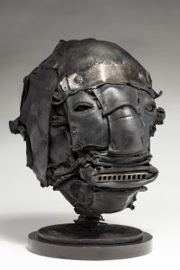Ronald Gonzalez -  <strong>Tune (side)</strong> (2018<strong style = 'color:#635a27'></strong>)<bR /> black leather, found objects, wire, wax, carbon, screws and metal filings over welded steel armatures,
12 x 8 x 10 inches