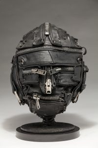 Ronald Gonzalez -  <strong>Zipped</strong> (2018<strong style = 'color:#635a27'></strong>)<bR /> black leather, found objects, wire, wax, carbon, screws and metal filings over welded steel armatures,
11 x 9 x 9 inches