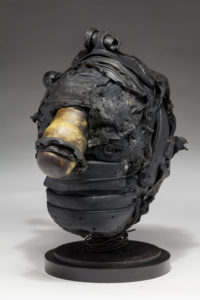 Ronald Gonzalez -  <strong>HITCH</strong> (2017<strong style = 'color:#635a27'></strong>)<bR /> 12 x 8 x 8. Leather, found objects, wire, wax, carbon, screws, and metal filings over welded steel armatures