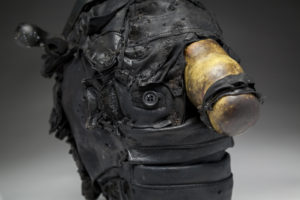 Ronald Gonzalez -  <strong>HITCH # 3</strong> (2017<strong style = 'color:#635a27'></strong>)<bR /> 12 x 8 x 8. Leather, found objects, wire, wax, carbon, screws, and metal filings over welded steel armatures
