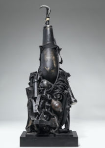 Ronald Gonzalez -  <strong>PROSTHETIC</strong> (2018<strong style = 'color:#635a27'></strong>)<bR /> 30 x 12 x 8. Leather, found objects, wire, wax, carbon, screws, and metal filings over welded steel armatures