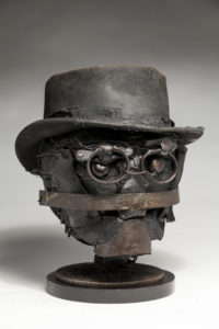 Ronald Gonzalez -  <strong>SPECTACLES</strong> (2018<strong style = 'color:#635a27'></strong>)<bR /> 12 x 9 x 12. Leather, found objects, wire, wax, carbon, screws, and metal filings over welded steel armatures.