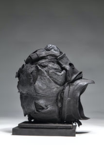 Ronald Gonzalez -  <strong>TRAGIC MASK</strong> (2016<strong style = 'color:#635a27'></strong>)<bR /> 11 x 7 x 9. Leather, found objects, wire, wax, carbon, screws, and metal filings over welded steel armatures