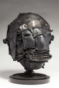Ronald Gonzalez -  <strong>TUNE</strong> (2018<strong style = 'color:#635a27'></strong>)<bR /> 12 x 8 x 8. Leather, found objects, wire, wax, carbon, screws, and metal filings over welded steel armatures.