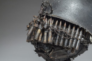 Ronald Gonzalez -  <strong>WAR RELICS # 4</strong> (2018-19<strong style = 'color:#635a27'></strong>)<bR /> Approx. 12 x 11 x 12. Leather, found objects, wire, wax, carbon, screws, and metal filings over welded steel armatures