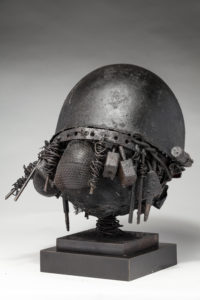 Ronald Gonzalez -  <strong>WAR RELICS # 6</strong> (2018-19<strong style = 'color:#635a27'></strong>)<bR /> Approx. 12 x 11 x 12. Leather, found objects, wire, wax, carbon, screws, and metal filings over welded steel armatures