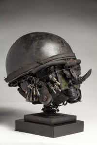 Ronald Gonzalez -  <strong>WAR RELICS # 9</strong> (2018-19<strong style = 'color:#635a27'></strong>)<bR /> Approx. 12 x 11 x 12. Leather, found objects, wire, wax, carbon, screws, and metal filings over welded steel armatures