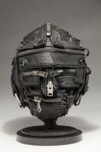 Ronald Gonzalez -  <strong>ZIPPED</strong> (2018<strong style = 'color:#635a27'></strong>)<bR /> 10 X 8 X 8. Leather, found objects, wire, wax, carbon, screws, and metal filings over welded steel armatures.